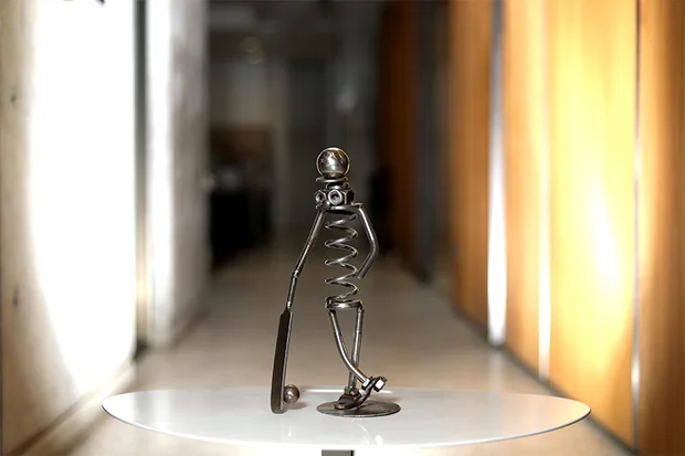 Figure with a coiled steel body