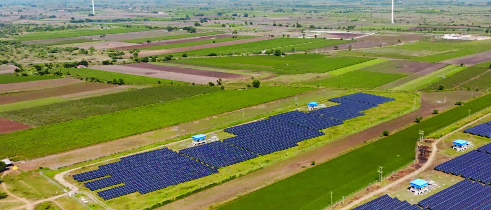 Aerial view of the farmland around the Laxcon Steels wind solar hybrid site, solar arrays running along the field edges